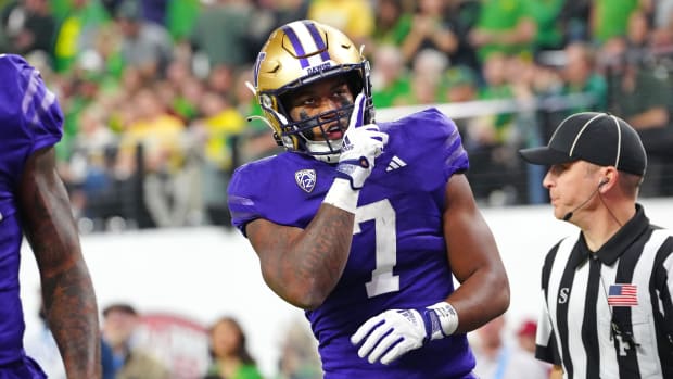 Washington Huskies running back Dillon Johnson (7) celebrates after scoring a touchdown against the Oregon Ducks during the first quarter at Allegiant Stadium.